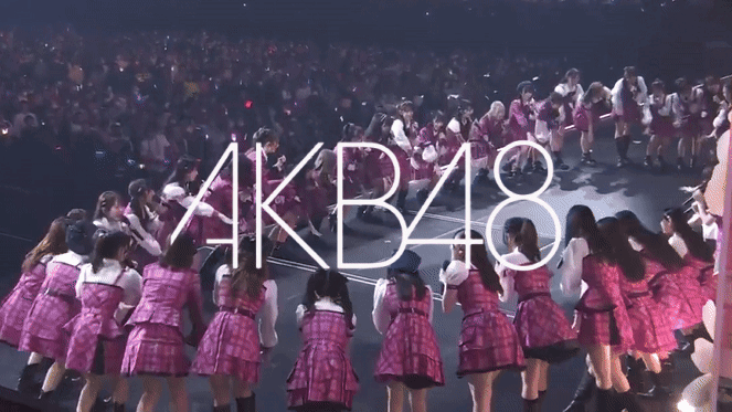 gif of a group of girls raising their hands together on a stage with the text A K B 48 overlayed