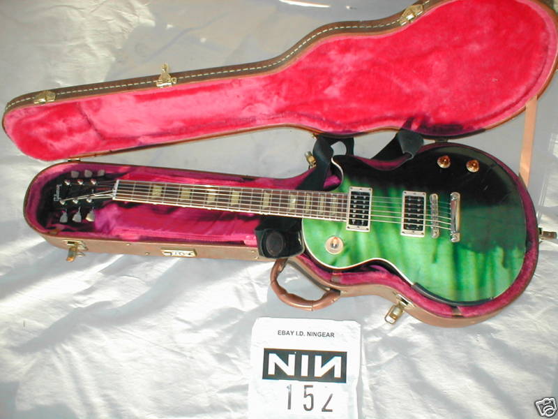 ebay listing labelled NIN 152 showing a green and black guitar in a case