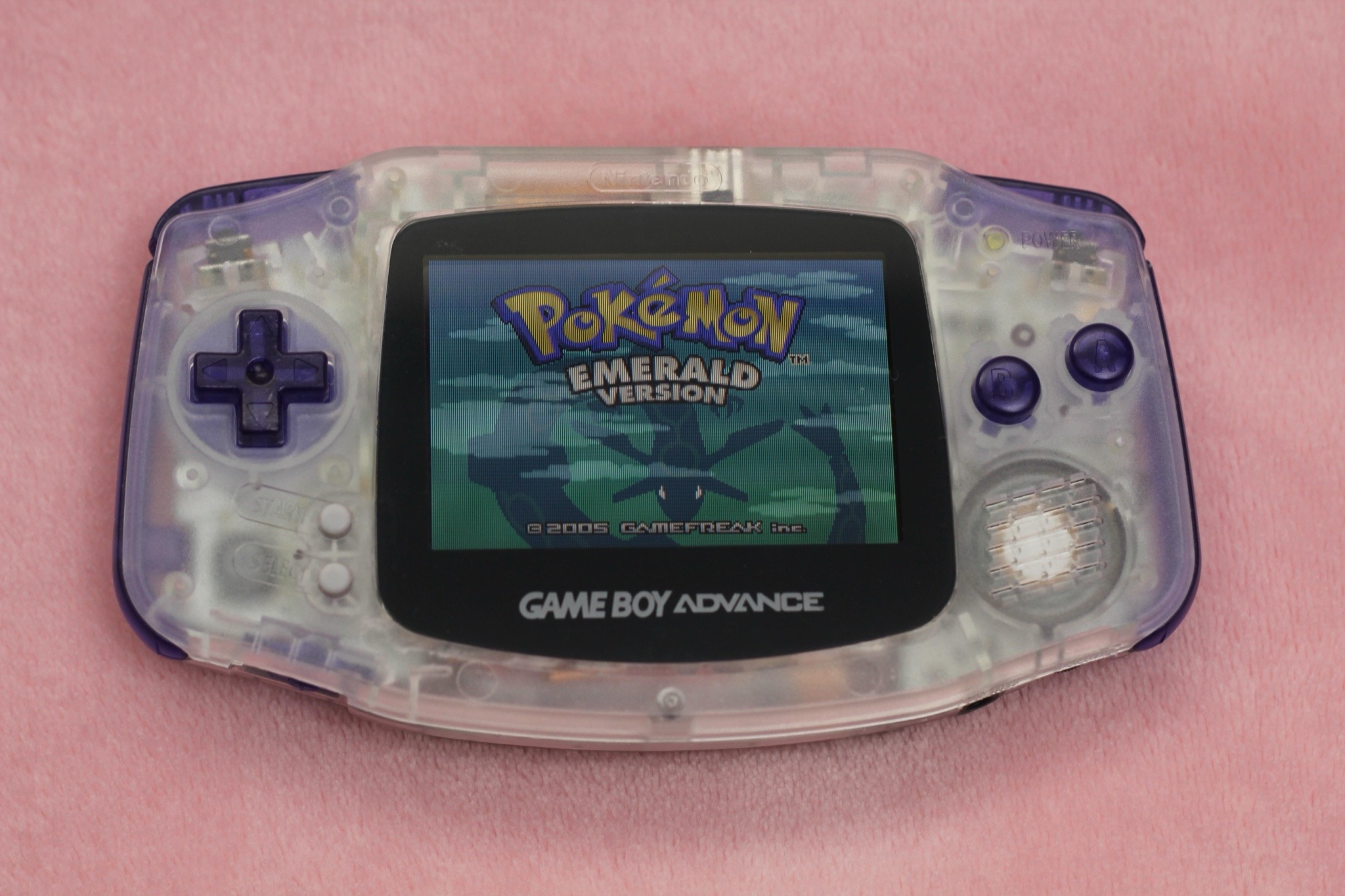 image of translucent purple game boy advance running pokemon emerald version