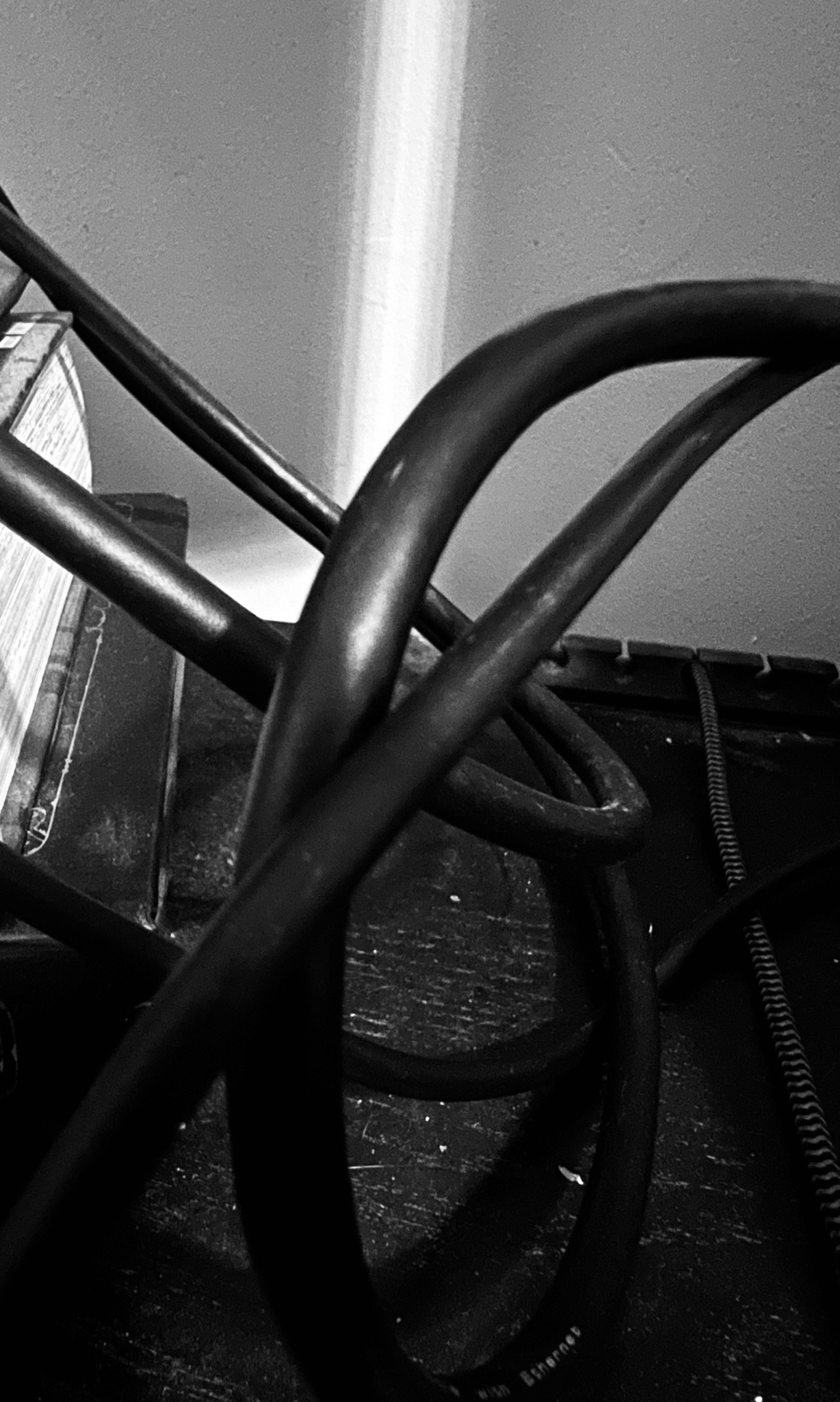 a black and white photo showing a tangle of black wires