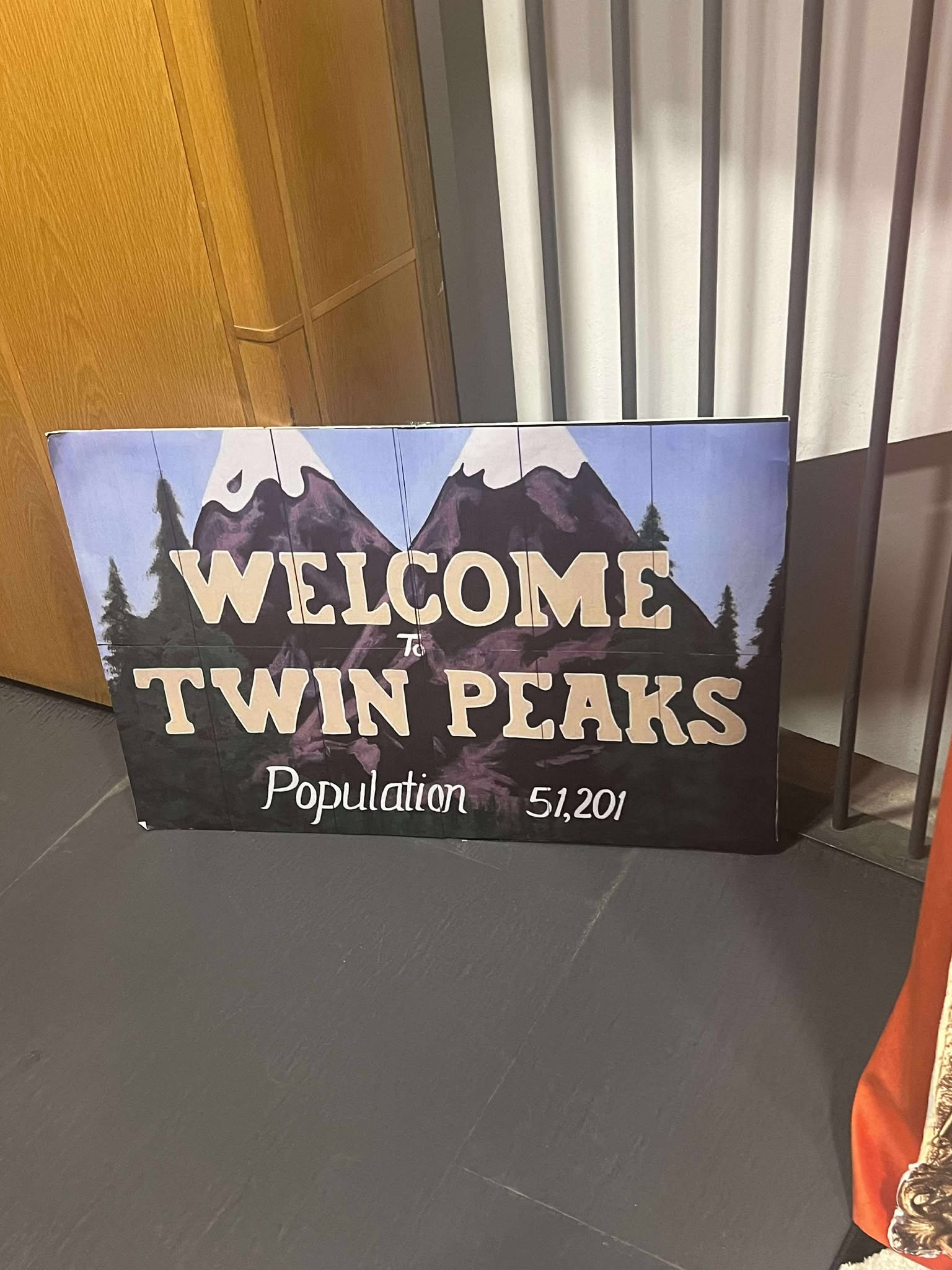 sign on the cinema wall reading Welcome to Twin Peaks population: 51,201